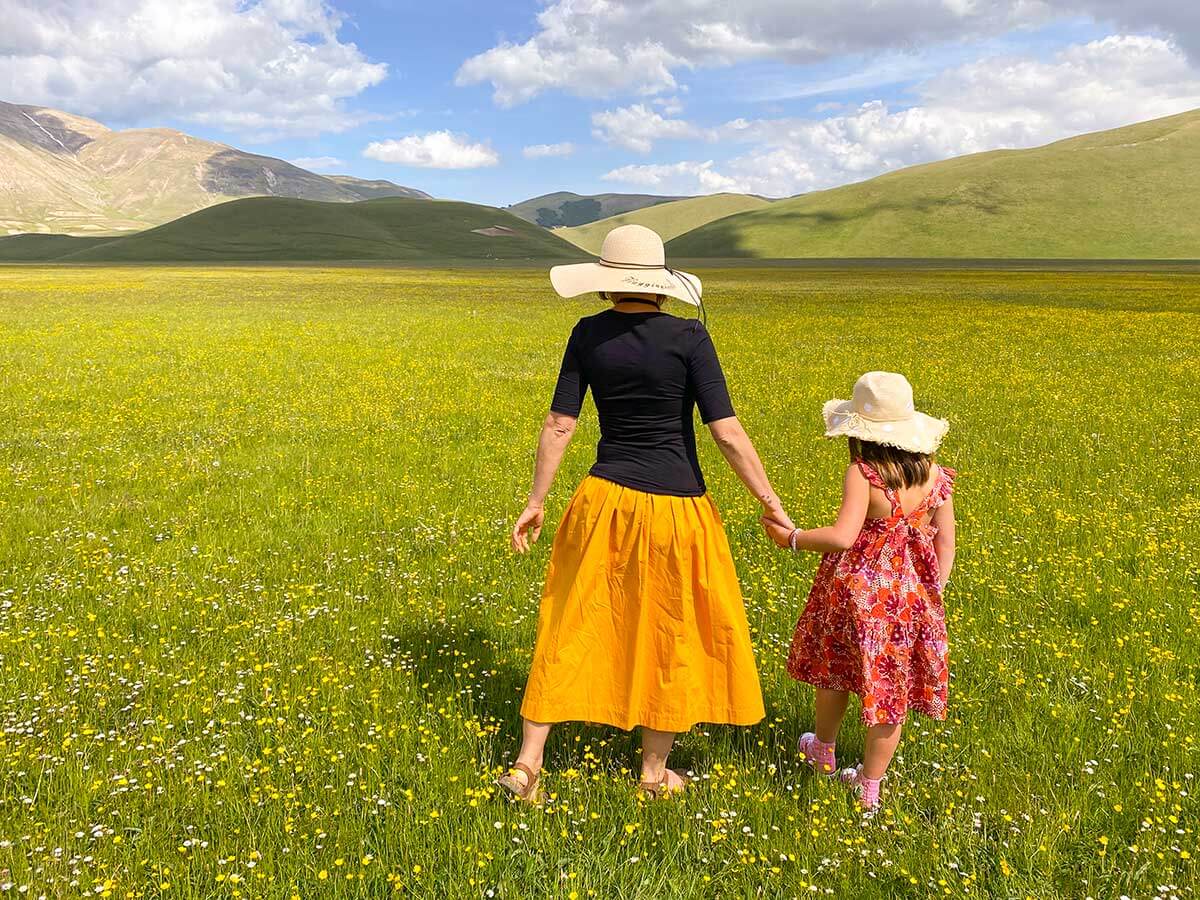 mamam e bambina di spalle in un prato