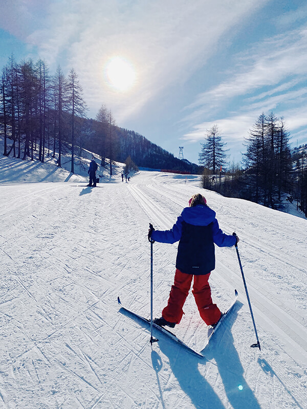 bambina sta salendo sulla pista di sci di fondo