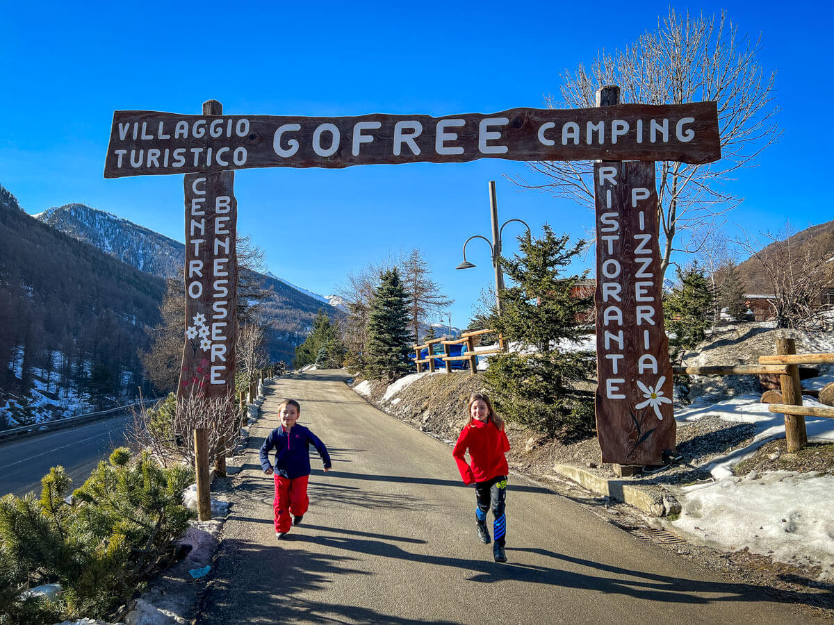 due bambini corrono davanti all'ingresso del Villaggio Gofree