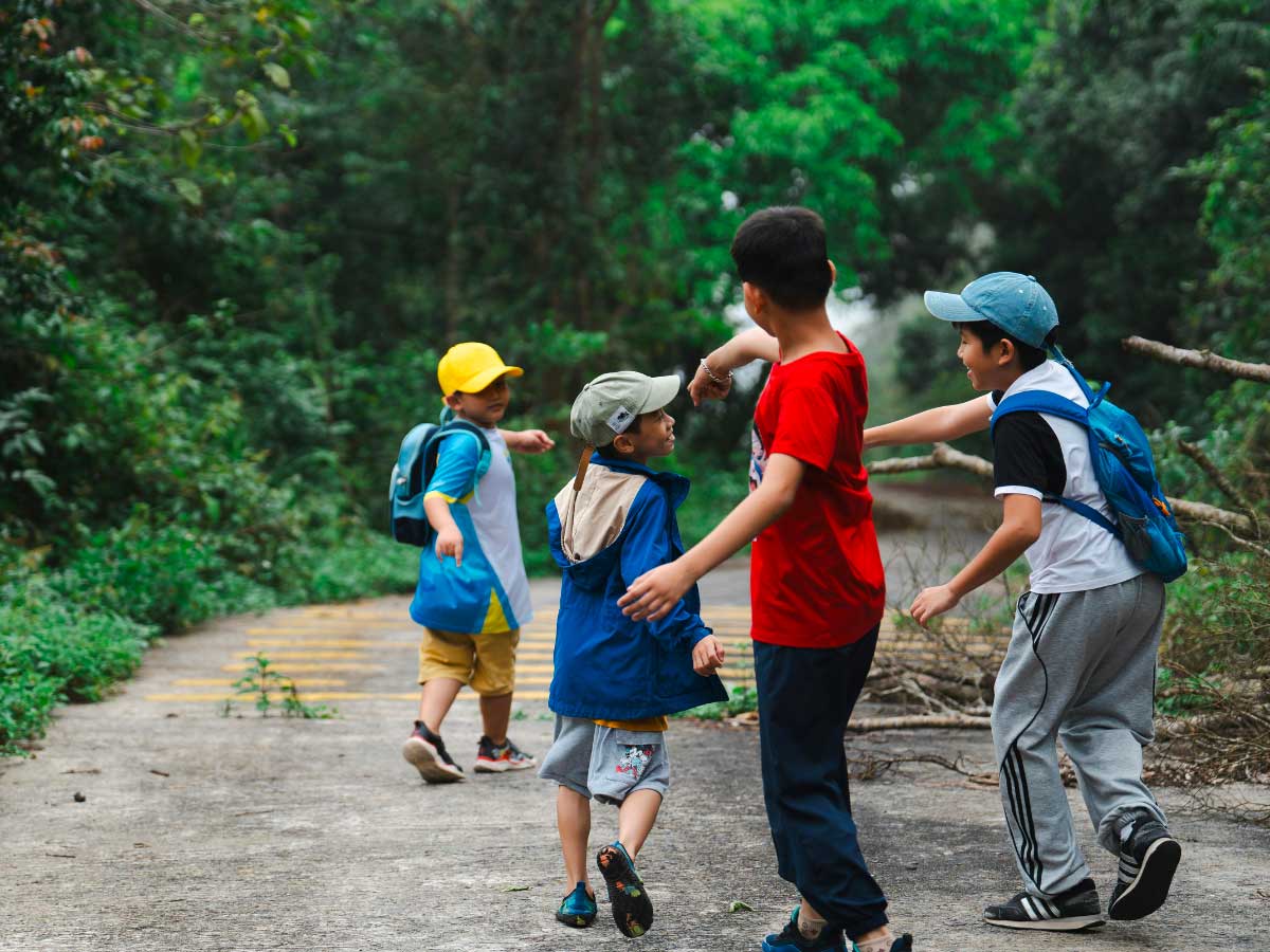 campo estivo nella natura con bambini che esplorano all’aperto