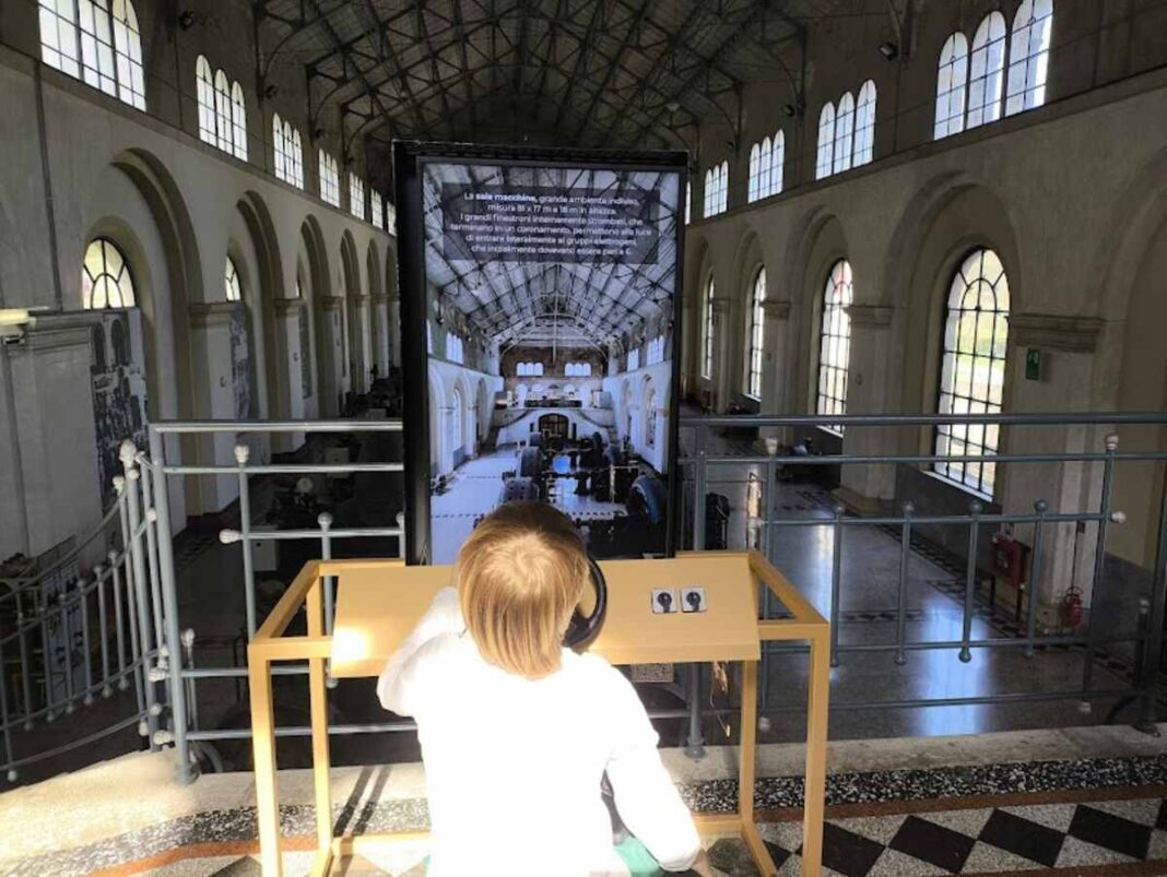 bambino gioca con totem interattivo alla centrale elettrica di malnisio